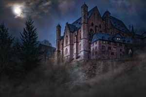 Creepy mansion on a hill at night